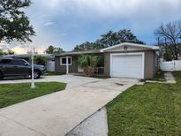 Charming single-story home with a well-maintained yard, driveway, and attached garage in a suburban setting at 8341 41St N Ave, St Petersburg, FL 33709