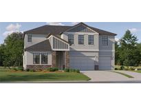 Inviting two-story home featuring a two-car garage, stone accents and charming landscaping at 9583 Runaway Breeze Dr, Land O Lakes, FL 34637