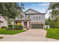 Charming two-story home with a well-manicured lawn, paver driveway, and a two-car garage at 10707 Pegasus Valley Ct, Tampa, FL 33647