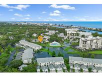 Breathtaking aerial view of a waterfront community, showcasing lush landscaping, serene lake, and coastal access at 11510 Shipwatch Dr # 1372, Largo, FL 33774