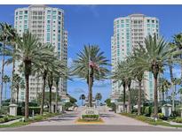 Luxury towers provide an exquisite backdrop amidst lush palm trees and a welcoming brick entrance at 1170 Gulf Blvd # 1006, Clearwater Beach, FL 33767