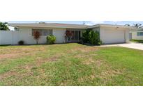 Well maintained exterior showing manicured landscaping, green lawn, and welcoming curb appeal at 13898 Jamaica Dr, Seminole, FL 33776