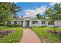 Charming single-story home with a brick walkway and well-maintained landscaping at 13917 8Th St, Dade City, FL 33525