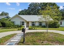 Charming single-story home with a metal roof, well-maintained landscaping, and welcoming curb appeal at 3315 W Hawthorne Rd, Tampa, FL 33611
