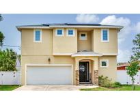 Charming two-story home featuring a welcoming front entrance and attached two-car garage at 3503 W Price Ave, Tampa, FL 33611
