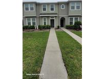 Inviting townhouse with well-maintained landscaping and neutral exterior paint at 8814 Walnut Gable Ct, Riverview, FL 33578