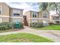 Inviting condo exterior with manicured landscaping and walkway leading to the entrance at 9481 Highland Oak Dr # 1504, Tampa, FL 33647