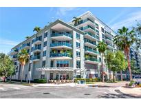 Modern condo building featuring private balconies with glass railings and tropical landscaping at 111 N 12Th St # 1805, Tampa, FL 33602