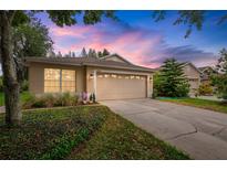 Charming single-story home with a two-car garage and well-maintained landscaping at 19204 Weymouth Dr, Land O Lakes, FL 34638