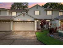 Charming townhome showcasing a well-maintained exterior with an attached garage and landscaped front yard at 3209 Meta Ct, Largo, FL 33771