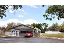 Charming single-story home with a porte-cochere and well-maintained front yard at 38819 Otis Allen Rd, Zephyrhills, FL 33540