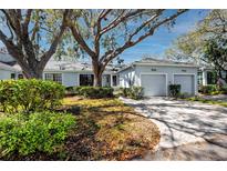 Charming exterior of a home featuring mature landscaping and an attached two-car garage at 944 San Carlos Ne Ct, St Petersburg, FL 33702
