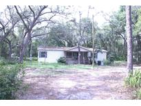 Exterior of a home with mature trees and a partially covered front porch at 10641 Atlee St, New Port Richey, FL 34654