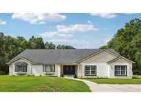 Charming home with a well-manicured lawn, showcasing its inviting curb appeal and a freshly painted exterior at 25238 Bunting Cir, Land O Lakes, FL 34639