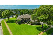 Beautiful single-story home featuring a well-manicured lawn, mature trees, and tasteful landscaping at 2847 Mossy Timber Trl, Valrico, FL 33596