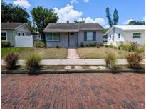 Charming single-story home featuring a walkway, tidy landscaping, and classic architectural details at 5048 5Th S Ave, St Petersburg, FL 33707