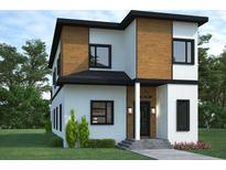 Modern two-story home with wood panel accents, black trim, manicured lawn, and elegant entrance at 5200 7Th N Ave, St Petersburg, FL 33710