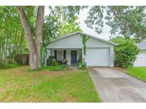 Charming single-story home with attached garage, front porch, and well-maintained lawn at 6412 S Richard Ave, Tampa, FL 33616