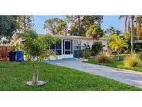 Charming single-story home featuring a well-manicured lawn and a paved driveway at 6901 10Th N St, St Petersburg, FL 33702