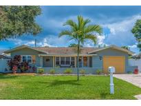 Charming single-story home with well-maintained lawn, tropical palm tree, and welcoming curb appeal at 10339 111Th St, Largo, FL 33778