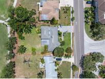 A beautiful home featuring a large lot surrounded by mature trees and meticulous landscaping at 167 Almedo Ne Way, St Petersburg, FL 33704