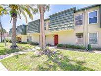 Inviting exterior showcasing palm trees, green lawn, and unique architectural details at 1799 N Highland Ave # 185, Clearwater, FL 33755