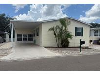 Charming single-story home with a carport, tidy landscaping, and classic design, creating a welcoming curb appeal at 250 S Port Royal Ln, Apollo Beach, FL 33572