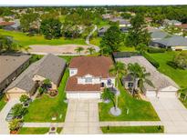 Spacious property featuring lush landscaping, a three-car garage, and a well-maintained exterior at 3633 Morgans Bluff Ct, Land O Lakes, FL 34639