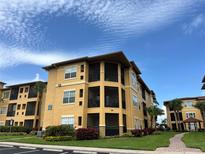 Exterior view of condo building with palm trees and blue sky at 4305 Bayside Village Dr # 301, Tampa, FL 33615