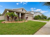 Charming single-Gathering home showcasing a well-manicured lawn and beautiful landscaping at 5006 Jackel Chase Dr, Wimauma, FL 33598