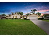 Charming single-story home with stone accents, well-manicured lawn, and an attached two-car garage at 5078 Florentine Ct, Spring Hill, FL 34608