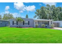 Charming single story home featuring a well-manicured lawn and welcoming front entrance at 5927 10Th N St, St Petersburg, FL 33703
