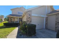 Charming home featuring a two-car garage, brick accents, and well-maintained landscaping at 6424 Thicket Trl, New Port Richey, FL 34653