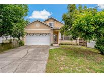 Charming two-story home with a well-maintained lawn, inviting curb appeal, and attached two-car garage at 6625 Interbay Blvd, Tampa, FL 33611