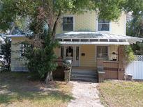 Charming two-story home with a covered porch, brick accents, and a welcoming stone walkway at 774 32Nd N Ave, St Petersburg, FL 33704