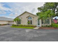 Charming home featuring arched windows, lush landscaping, and a welcoming entrance at 1111 Golfview Woods Dr # 1111, Sun City Center, FL 33573