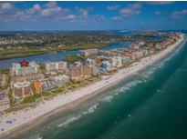 Aerial view showcasing beachfront condos near the coastline at 19531 Gulf Blvd # 306, Indian Shores, FL 33785