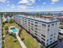 An aerial view of the condo, community pool, landscaping and coastal location at 2960 59Th S St # 303, Gulfport, FL 33707