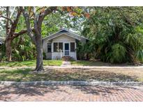 Charming bungalow-style home with a brick sidewalk and lush, mature landscaping at 317 19Th S Ave, St Petersburg, FL 33705