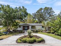 Beautiful home with circular driveway, mature landscaping, and modern exterior design at 454 35Th Ne Ave, St Petersburg, FL 33704
