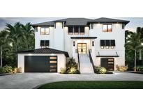 A modern two-story home with black accents and lush landscaping at 10126 Tarpon Dr, Treasure Island, FL 33706