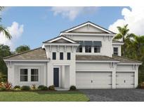 Elegant two-story home boasting a three-car garage and manicured lawn, offering a blend of comfort and sophistication at 10305 Longmeadow Ave, Parrish, FL 34219