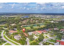 Beautiful aerial view of a golf course community with mature landscaping and lakes at 2518 Dick Wilson Dr, Sarasota, FL 34240