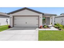 Beautiful home featuring an attached two car garage and a well manicured front yard at 29563 Fedora Cir, Brooksville, FL 34602