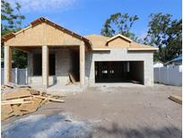 Exterior view of a home under construction showing the frame and foundation work in progress, garage entrance, and basic structure at 3110 19Th N St, St Petersburg, FL 33713