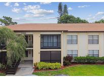 Two story multi Gathering unit with front landscape, stairwell access and second story balcony at 3389 Crystal E Ct # J, Palm Harbor, FL 34685