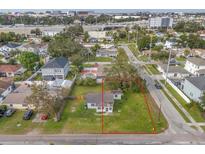Aerial view of a property with a spacious green yard and an outlining red border at 4001 W Carmen St, Tampa, FL 33609