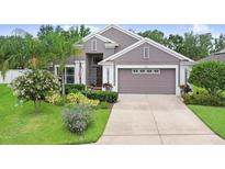 Charming single-story home featuring a well-manicured lawn and a two car garage at 5013 119Th E Ter, Parrish, FL 34219