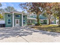 Stunning home featuring a unique color scheme and eye-catching architectural details at 5657 Oceanic Rd, Holiday, FL 34690