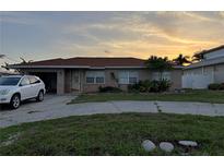 Charming single story home with mature landscaping and a large driveway at sunset at 6820 26Th W St, Bradenton, FL 34207